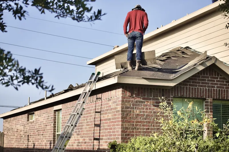 Professional roofer working on a residential roof in Navy